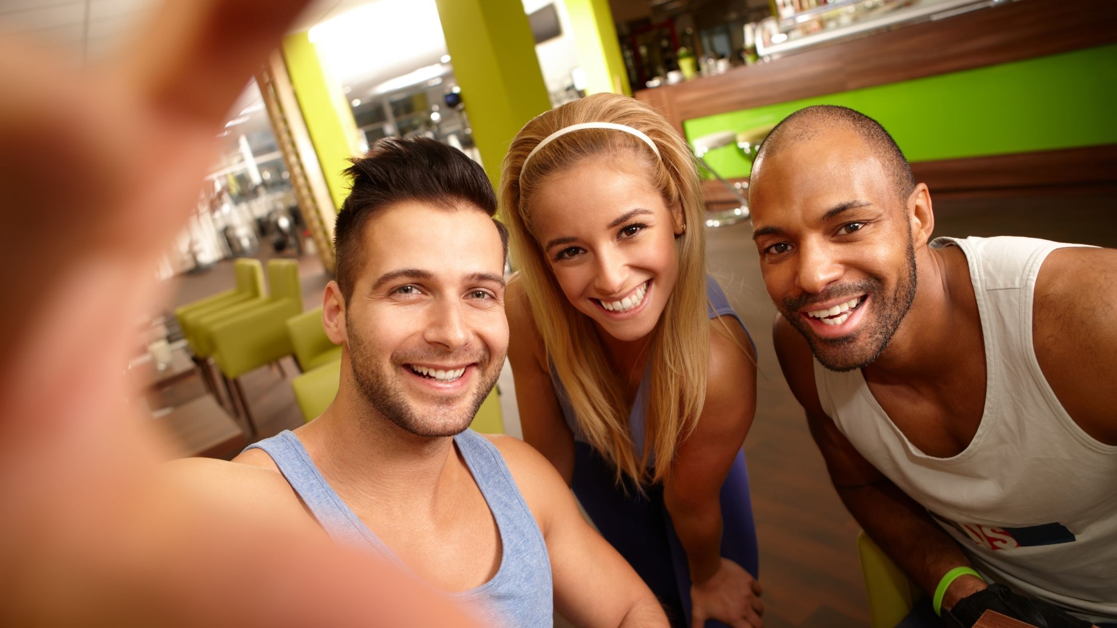Selfi de 3 jóvenes sonriendo antes o después de haber hecho ejercicio
